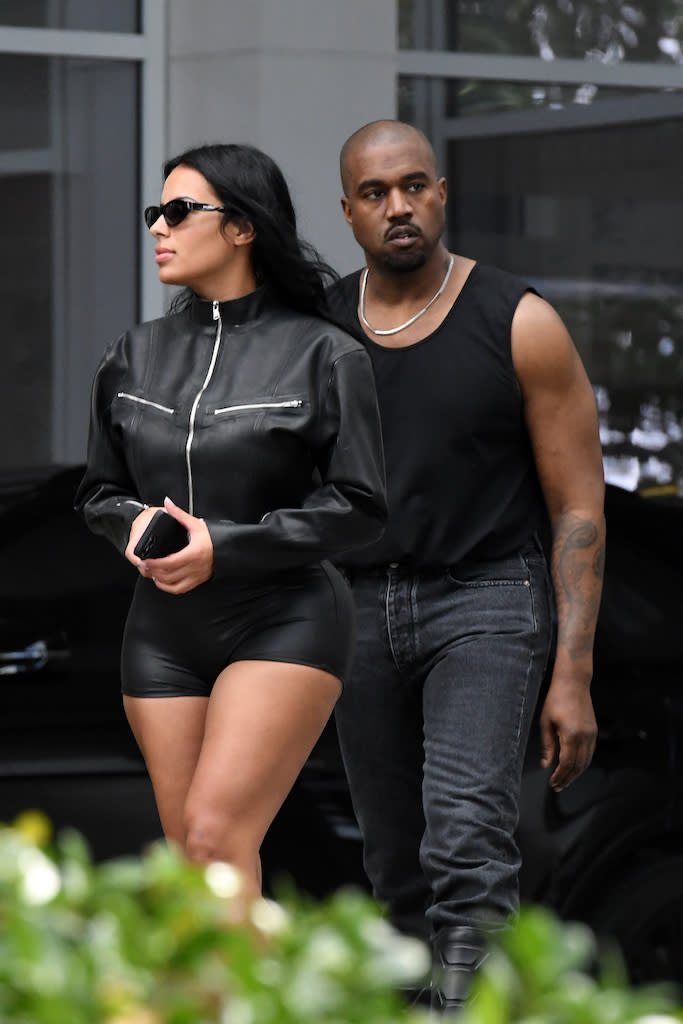 Kanye West with Chaney Jones in all-black outfits paired with rugged tall black boots in Miami on March 3, 2022. - Credit: MEGA