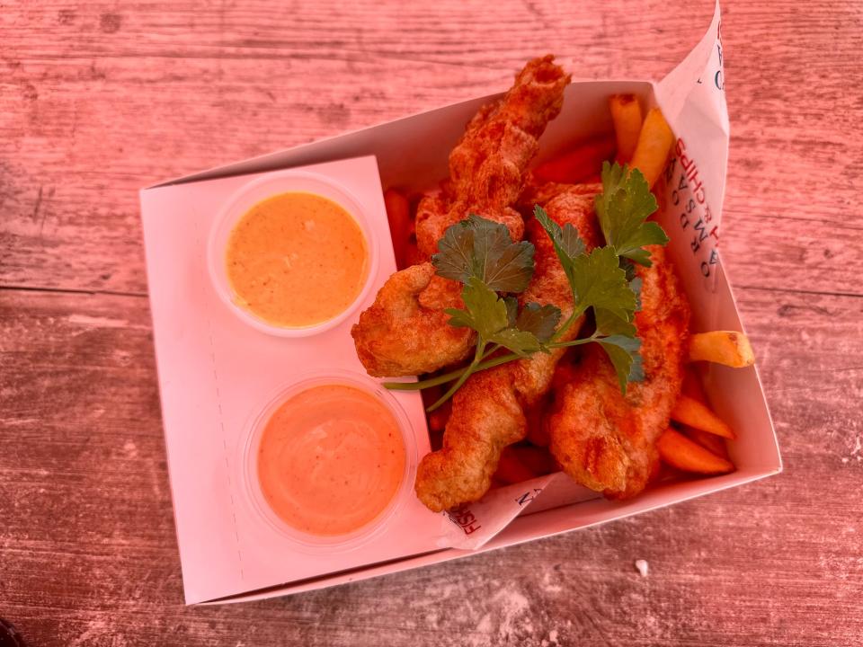 An order of chicken tenders with fries and dipping sauces