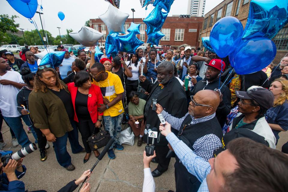 Guests gather and listen to community leaders speak during a vigil for Eric Logan on Monday, June 17, 2019, on Washington Street in South Bend.  Logan, 54, was killed in South Bend early Sunday after someone called police to report a suspicious person going through cars, according to the St. Joseph County prosecutor's office.