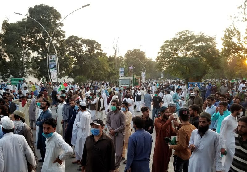 People gather to protest against the cartoon publications of Prophet Mohammad in France and French President Emmanuel Macron's comments, in Islamabad