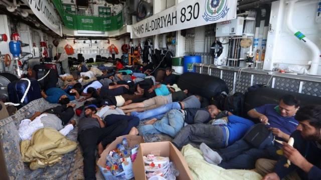 Evacuees rest aboard a Saudi naval vessel as it travels from Port Sudan to Jeddah on April 30, 2023