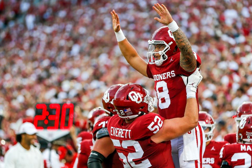 Oklahoma's Dillon Gabriel (8) celebrates scoring a touchdown with Oklahoma’s Troy Everett (52) in the first quarter during an NCAA football game between University of Oklahoma (OU) and Iowa State at the Gaylord Family Oklahoma Memorial Stadium in Norman, Okla., on Saturday, Sept. 30, 2023.