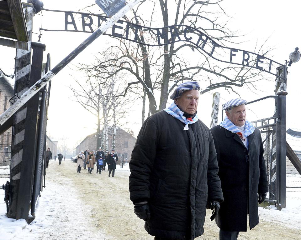 Survivors of Auschwitz gather on the 74th anniversary of the liberation of the former Nazi German death camp in Oswiecim, Poland, on Sunday, Jan. 27, 2019. They wore striped scarves that recalled their uniforms, some with the red letter "P," the symbol the Germans used to mark them as Poles. The observances come on International Holocaust Remembrance Day.(AP Photo/Czarek Sokolowski)