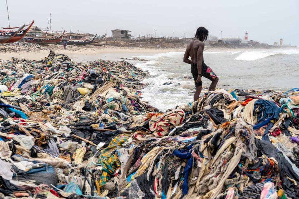Nii, a local fishermen, wades through the rags (Muntaka Chasant/Shutterstock)