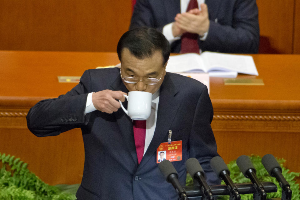 Chinese Premier Li Keqiang sips from cup as he delivers the work report at the opening session of the annual National People's Congress in Beijing's Great Hall of the People, Sunday, March 5, 2017. China's top leadership as well as thousands of delegates from around the country are gathered at the Chinese capital for the annual legislature meetings. (AP Photo/Ng Han Guan)