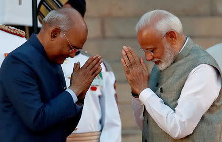 India's President Ram Nath Kovind greets India's Prime Minister Narendra Modi after his oath during a swearing-in ceremony at the presidential palace in New Delhi, India May 30, 2019. REUTERS/Adnan Abidi