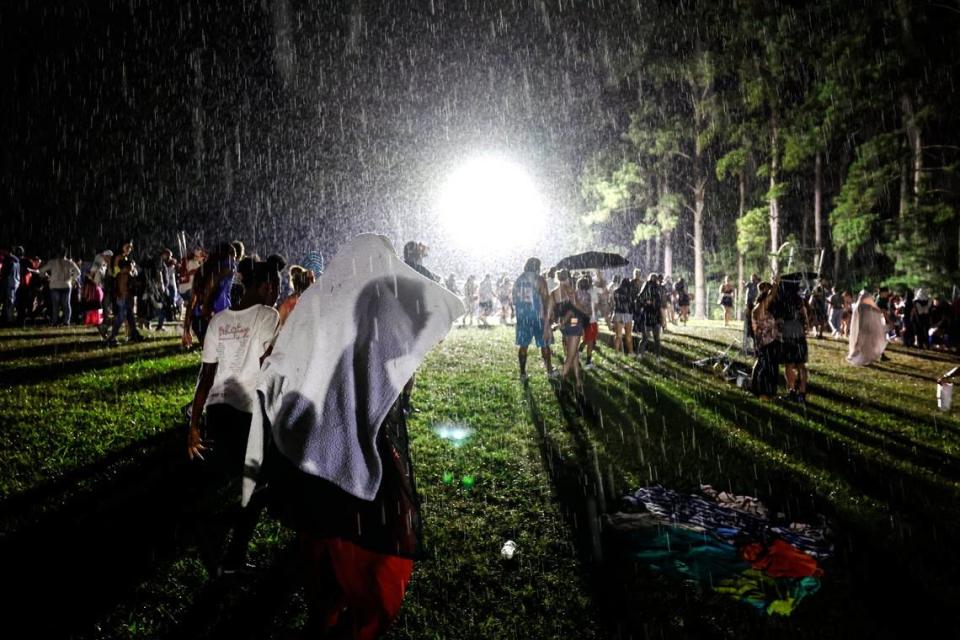 Attendees start to stream out of Dorothea Dix Park in Raleigh, N.C., after they were told to leave the area as a storm passes through minutes before the fireworks show was suppose to start Thursday evening, July 4, 2024. Attendees were then told they could stay as the rain got heavier.