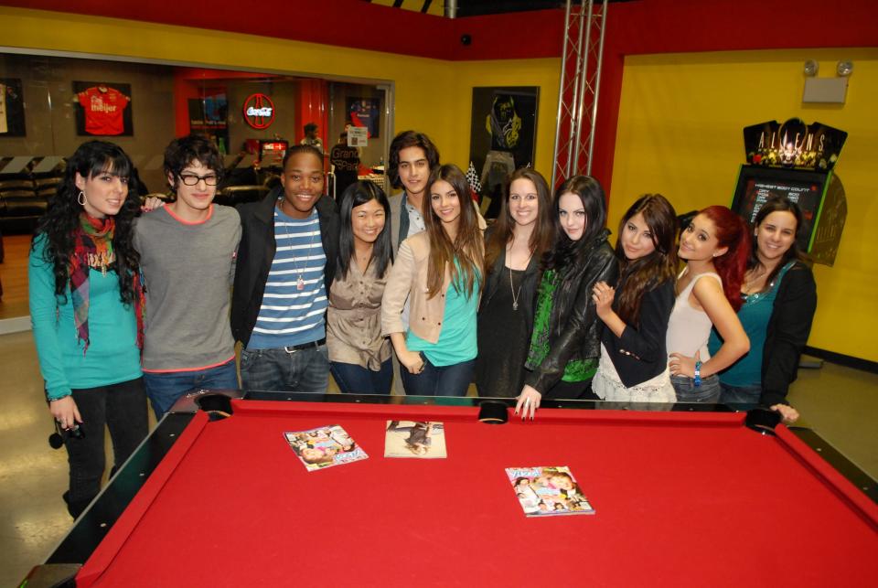 Author Rachel Chang with the "Victorious" cast in front of a pool table in the early 2000s 