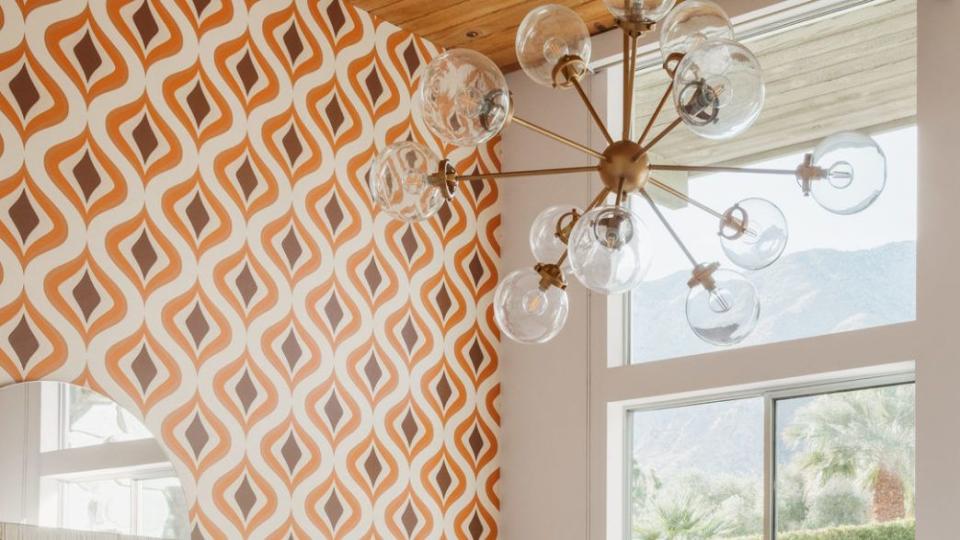 bedroom accent wall with orange and red pattern