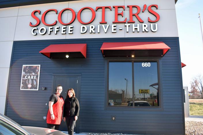 Manager Jessica McKinney and owner Deb Auen pose outside Scooter&#39;s Coffee in Huxley Dec. 8, 2021.