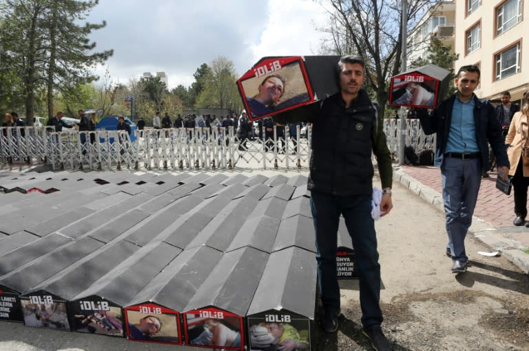 A man carries a symbolic coffin during a protest in Ankara against Russia's alleged role in a chemical attack in Syria