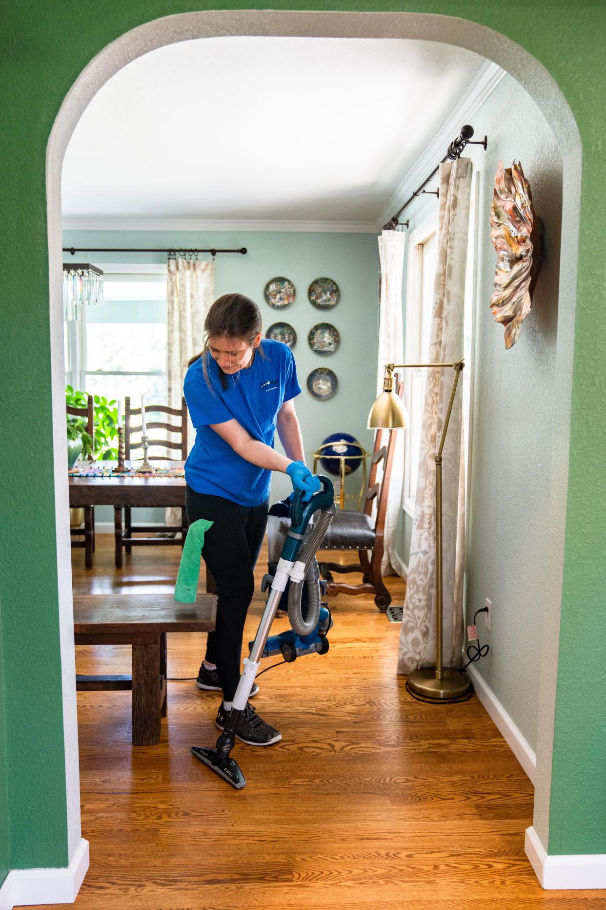 All Star Cleaning Services' Chrysten Svedarsky vacuums in the Fort Collins home of its founder, Laura Christian, on Tuesday.
