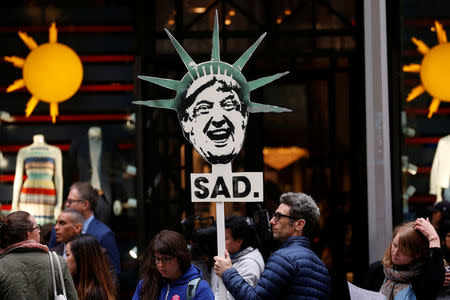 A protester demonstrates near Trump Tower against President Donald Trump in Manhattan. REUTERS/Mike Segar