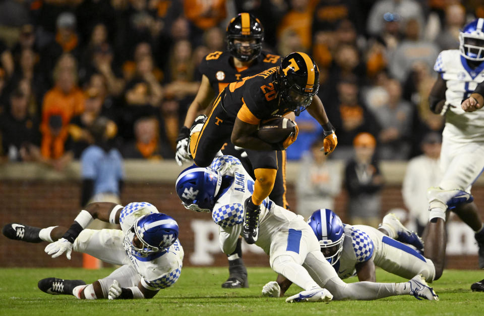 KNOXVILLE, TENNESSEE - OCTOBER 29: Jaylen Wright #20 of the Tennessee Volunteers hurdles Tyrell Ajian #6 of the Kentucky Wildcats in the second quarter of the game at Neyland Stadium on October 29, 2022 in Knoxville, Tennessee. (Photo by Eakin Howard/Getty Images)