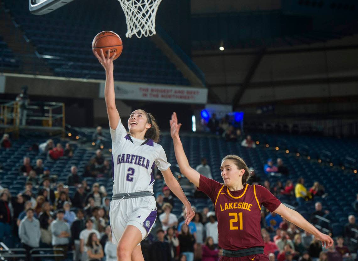 Garfield guard Katie Fiso (2) smiles as she goes up for a breakaway layup following a steal in the fourth quarter against Lakeside of Seattle in the quarterfinals of the Class 3A girls state basketball tournament on Thursday, March 2, 2023 at the Tacoma Dome in Tacoma, Wash.