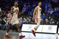 UNLV guard Luis Rodriguez (15) and UNLV guard Justin Webster (2) celebrate after defeating Creighton in an NCAA college basketball game Wednesday, Dec. 13, 2023, in Henderson, Nev. (AP Photo/John Locher)