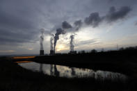 Smoke rises from chimneys of the Turow power plant located by the Turow lignite coal mine near the town of Bogatynia, Poland, Tuesday, Nov. 19, 2019. The Turow lignite coal mine in Poland has an impact on the environment and communities near the border of three neighboring countries, the Czech Republic, Germany and Poland. Plans to further expand the huge open pit mine have caused alarm among residents who fear things might get even worse. (AP Photo/Petr David Josek)