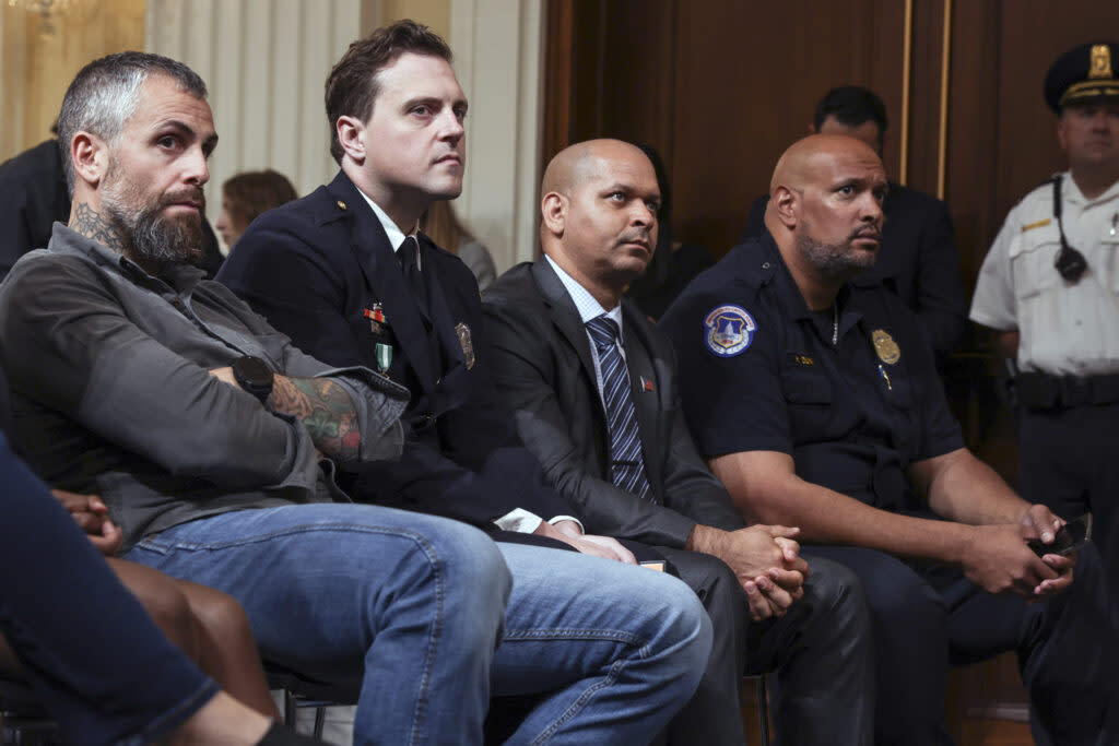 police officers listening to a Jan. 6 hearing