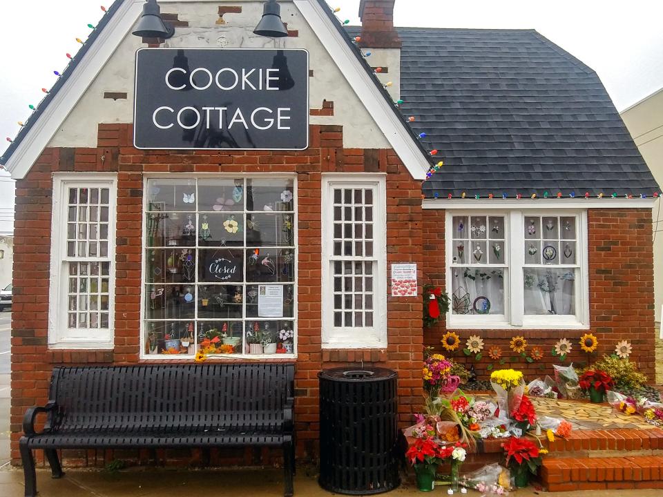 Flowers and chalked messages could be found Monday around the Cookie Cottage in Norman. A vigil also was planned to honor Shannon Hanchett, the owner of Okie Baking Co. who died last week while in the Cleveland County jail.