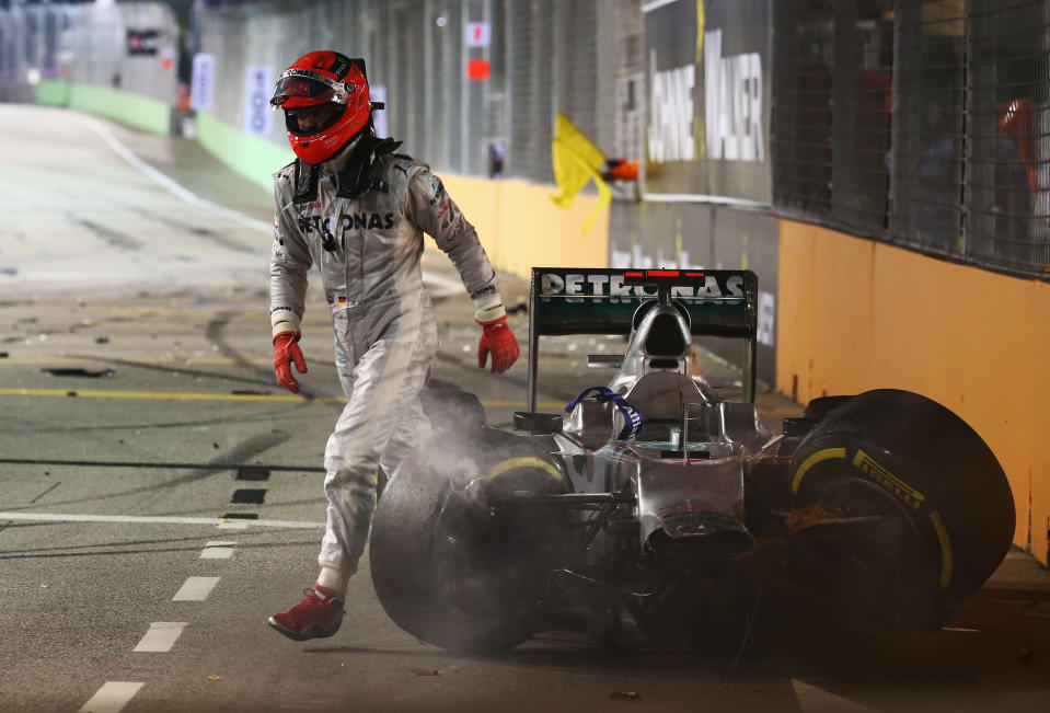 SINGAPORE - SEPTEMBER 23: Michael Schumacher of Germany and Mercedes GP retires early after crashing into the back of Jean-Eric Vergne of France and Scuderia Toro Rosso during the Singapore Formula One Grand Prix at the Marina Bay Street Circuit on September 23, 2012 in Singapore, Singapore. (Photo by Robert Cianflone/Getty Images)