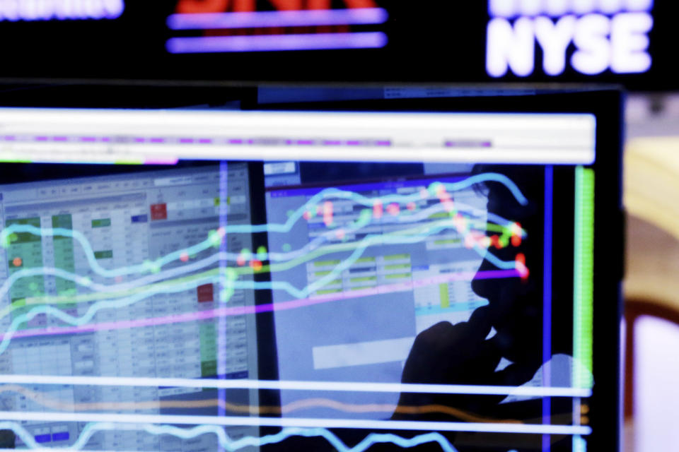 FILE - In this Monday, Jan. 11, 2016, file photo, specialist Anthony Rinaldi is silhouetted on a screen at his post on the floor of the New York Stock Exchange. Stocks are at peak levels. Bonds are making money despite a raft of predictions to the contrary at the start of 2017. Even stock markets overseas, notoriously poor investments for much of the last decade, are perking higher. If it feels precarious to have so many investments doing so well, even when the economy itself is still growing only modestly, markets are giving few indications of worry. But contrarians are feeling more reasons to pause. (AP Photo/Richard Drew, File)