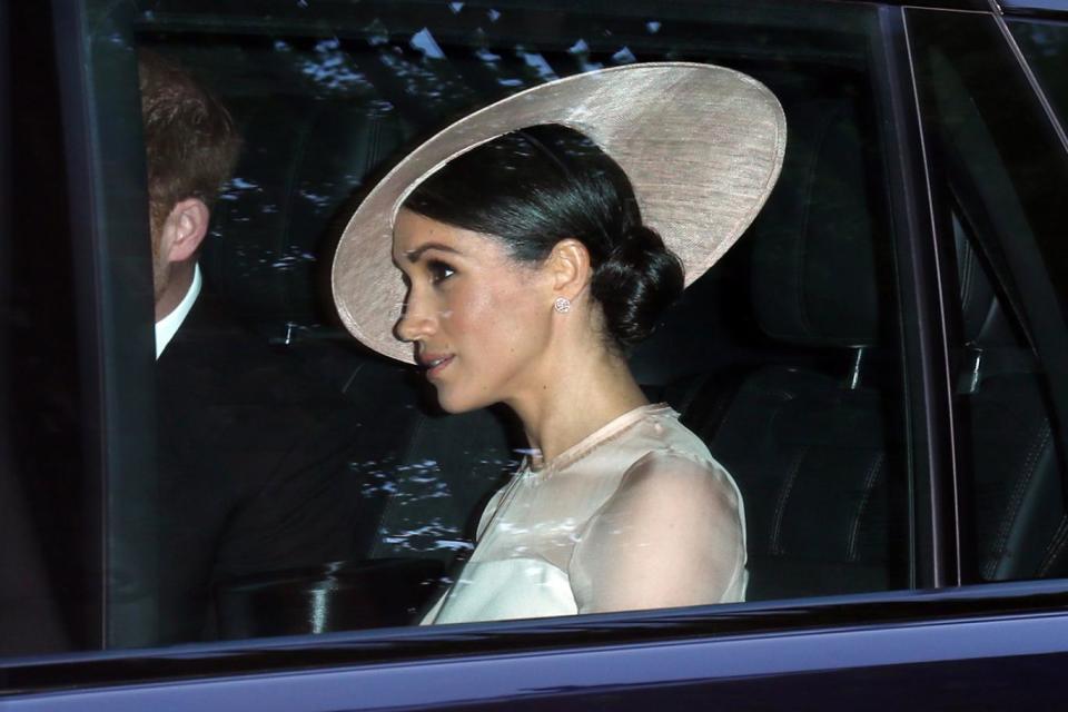 Meghan Markle heads to the party sitting next to Prince Harry (GC Images)