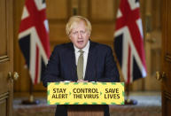 In this photo issued by 10 Downing Street, Britain's Prime Minister Boris Johnson speaks during a media briefing on coronavirus in Downing Street, London, Sunday May 24, 2020. Boris Johnson says he won't fire his chief aide Dominic Cummings for allegedly violating the national coronavirus lockdown rules that he helped to create. (Andrew Parsons/10 Downing Street via AP)