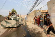 Children welcome Kurdish Peshmerga fighters after peshmerga recaptured from Islamic state militant, the Fadiliya village in Nawaran, north of Mosul, Iraq, October 27, 2016. REUTERS/Air Jalal TPX IMAGES OF THE DAY