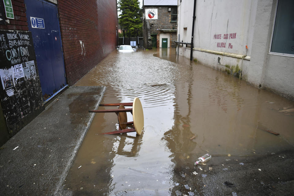 A view of a flooded street, in Pontypridd, Wales, Sunday, Feb. 16, 2020. Storm Dennis roared across Britain with high winds and heavy rains Sunday, prompting authorities to issue some 350 flood warnings, including a “red warning" alert for life-threatening flooding in south Wales. (Ben Birchall/PA via AP)