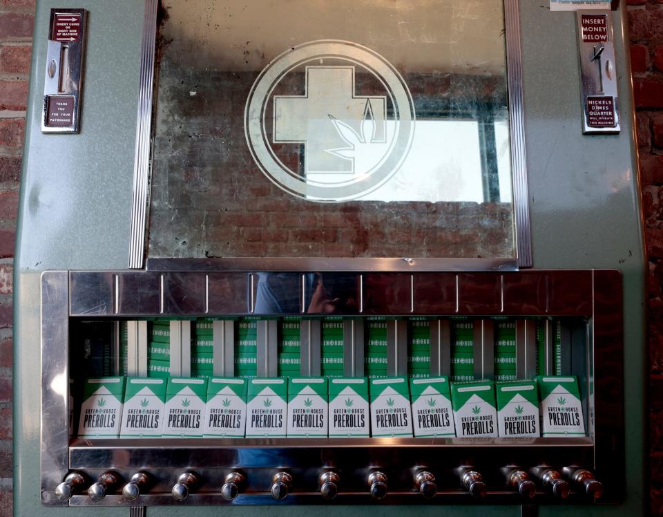 A vintage cigarette machine filled with Greenhouse pre-rolls of marijuana at Greenhouse of Walled Lake in Walled Lake on July 18, 2023. When entering any dispensary, you need to have a driver's license or state ID showing that you are 21. Dispensaries also take only cash but have ATM machines available for use.