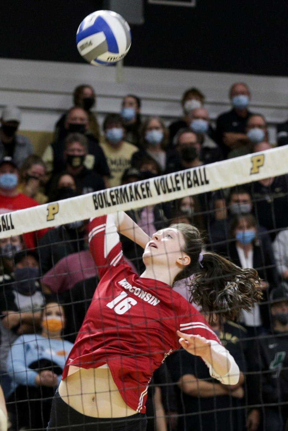 Wisconsin middle blocker Dana Rettke (16) goes up to hit the ball during the second set of an NCAA women's volleyball game, Sunday, Oct. 31, 2021 at Holloway Gymnasium in West Lafayette.