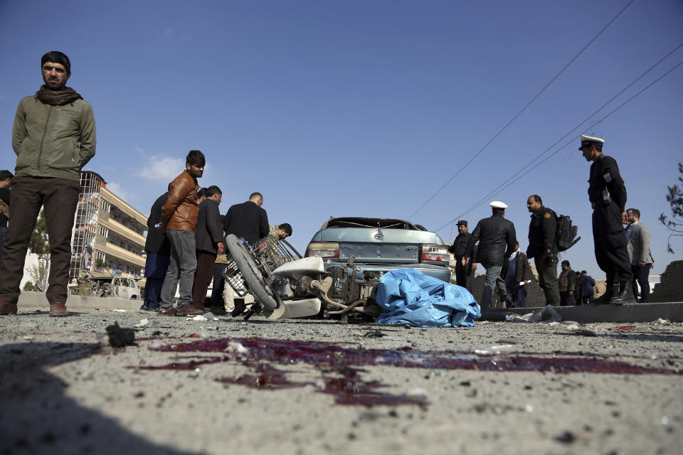 Afghan security personnel gather at the site of a car bomb attack in Kabul, Afghanistan, Wednesday, Nov. 13, 2019. A car bomb detonated in the Afghan capital of Kabul during Wednesday's morning commute, killing several people, officials said. (AP Photo/Rahmat Gul)