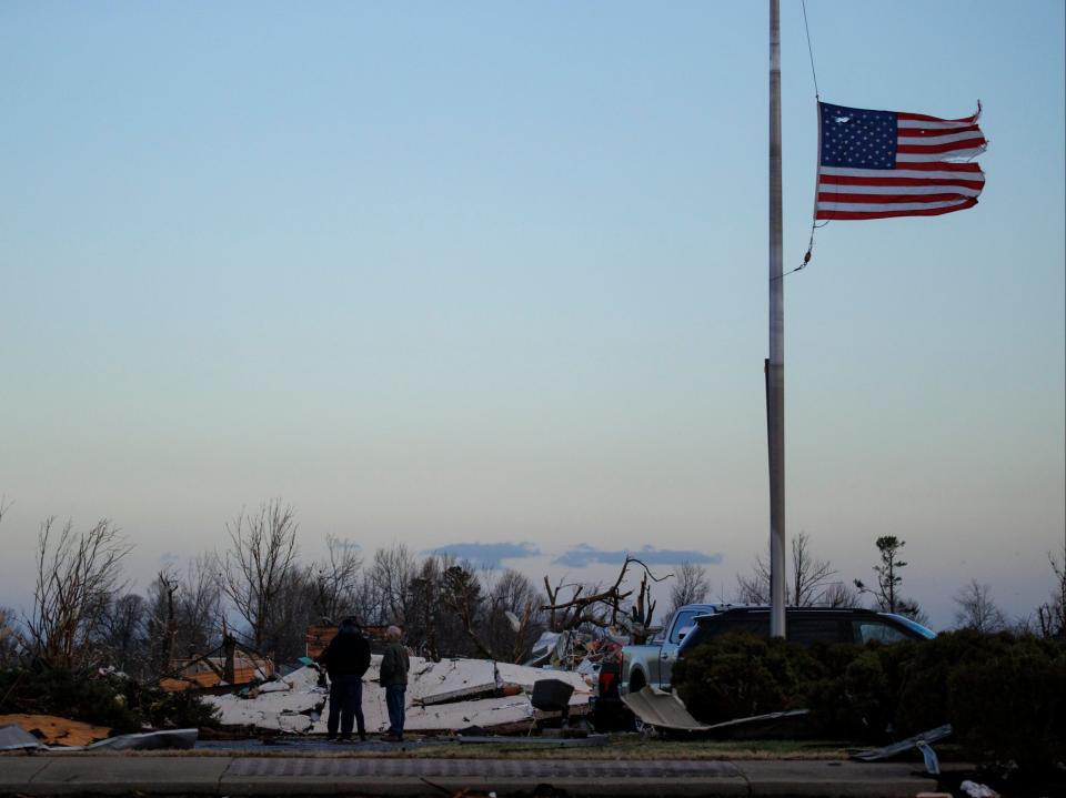 People survey tornado damage of the downtown area on December 11, 2021 in Mayfield, Kentucky (Getty Images)