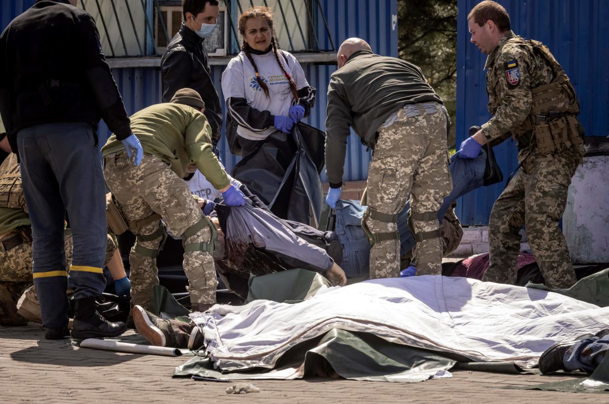 Ukrainian soldiers clear out bodies after a rocket at a train station in Kramatorsk, eastern Ukraine, that was being used for civilian evacuations. (AFP via Getty Images)