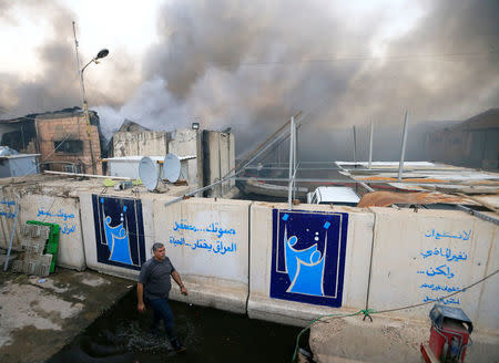 Smoke rises from a storage site in Baghdad, housing ballot boxes from Iraq's May parliamentary election, Iraq June 10, 2018. REUTERS/Thaier Al-Sudani