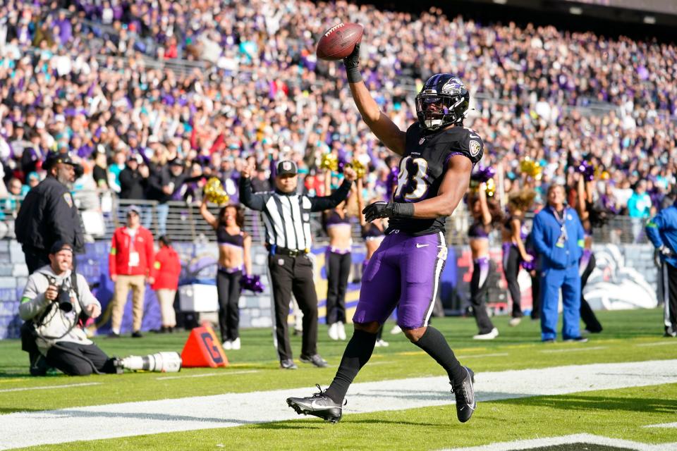 Baltimore Ravens running back Justice Hill (43) celebrates his touchdown catch against the Miami Dolphins during the first half of an NFL football game in Baltimore, Sunday, Dec. 31, 2023.