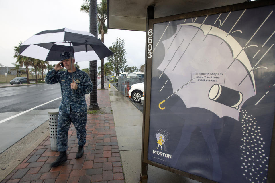 Cdr. Erik Fraven walks past a bus stop on Seal Beach Boulevard in Seal Beach, Calif., Jan. 20, 2017. (Photo by Jeff Gritchen/The Orange County Register via AP)