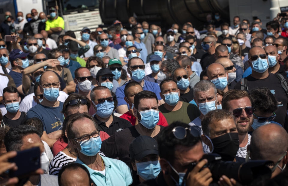 Nissan workers gather during a protest in front of the Nissan factory in Barcelona, Spain, Thursday, May 28, 2020. Japanese carmaker Nissan Motor Co. has decided to close its manufacturing plans in the northeastern Catalonia region, resulting in the loss of some 3,000 direct jobs. (AP Photo/Emilio Morenatti)