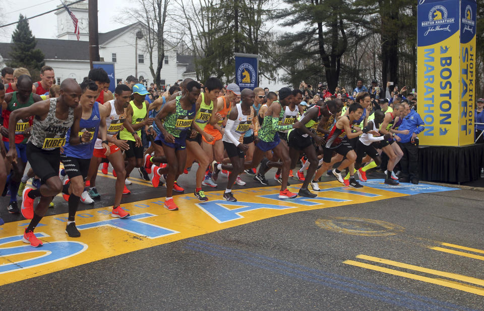 FILE - In this April 15, 2019, file photo, the elite men break from the start of the 123rd Boston Marathon in Hopkinton, Mass. The Boston Marathon is offering refunds for the first time because of the new coronavirus pandemic. Race organizers say anyone who was entered in the 124th edition of the race this month can still run on the rescheduled date, Sept. 14. But if they can’t make it, they can have their money back. (AP Photo/Stew Milne, File)