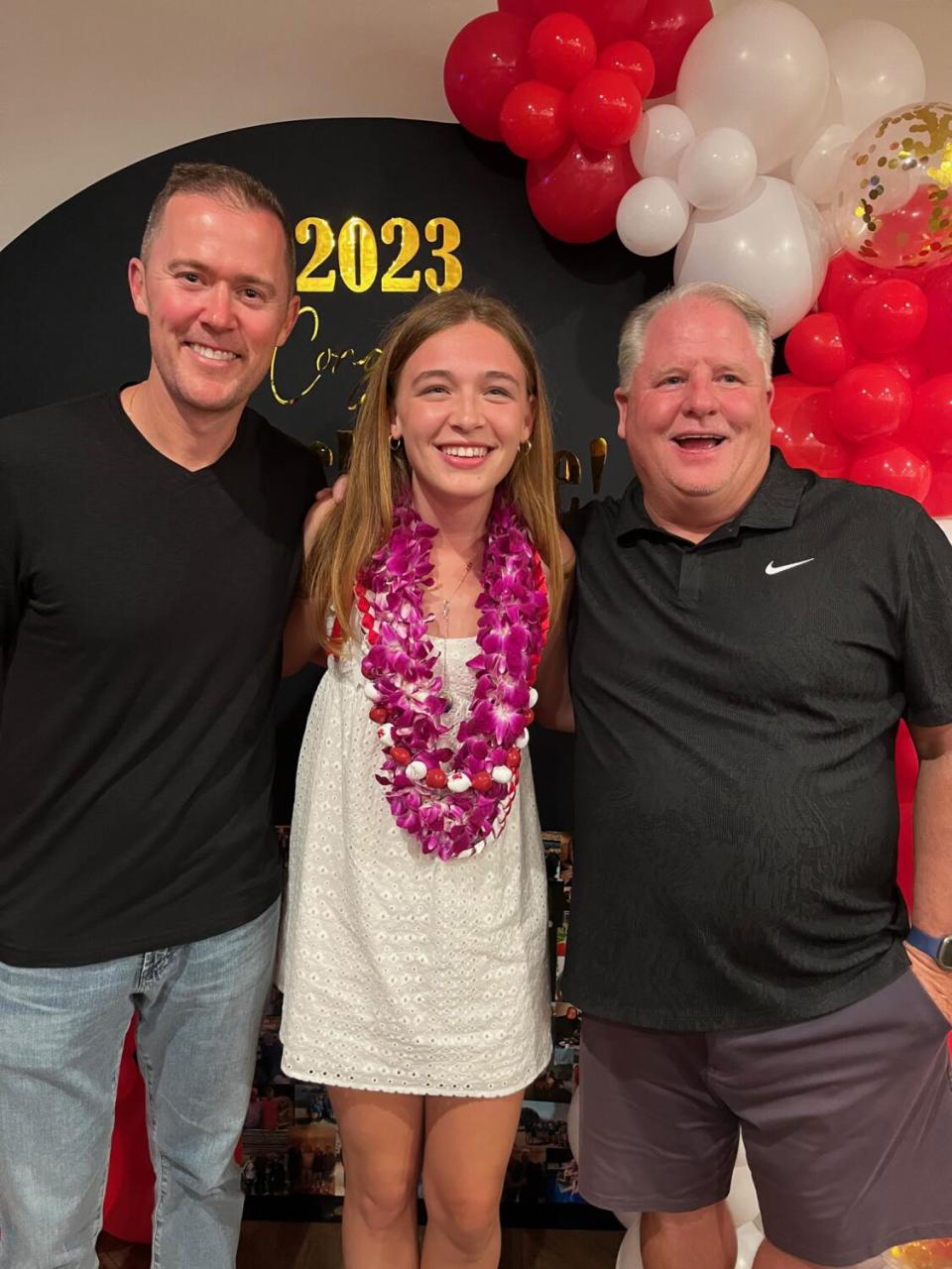 USC football coach Lincoln Riley, left, and UCLA football coach Chip Kelly, right, pose for a photo with Mackenzie McGovern.