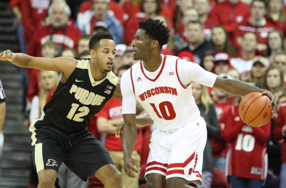 Dec 29, 2015; Madison, WI, USA; Wisconsin Badgers forward Nigel Hayes (10) looks to pass the ball as Purdue Boilermakers forward Vince Edwards (12) defends during the first half at the Kohl Center. Mandatory Credit: Mary Langenfeld-USA TODAY Sports