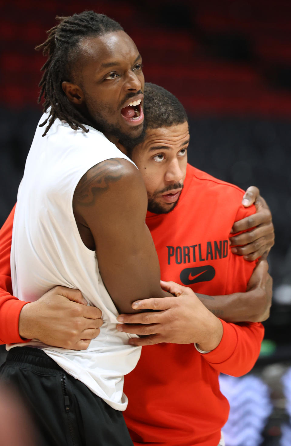 Nov 19, 2023; Portland, Oregon, USA; Portland Trail Blazers forward Jerami Grant (9) hugs assistant coach Mark Tyndale during warm ups before a game against the Oklahoma City Thunder at Moda Center. Mandatory Credit: Jaime Valdez-USA TODAY Sports