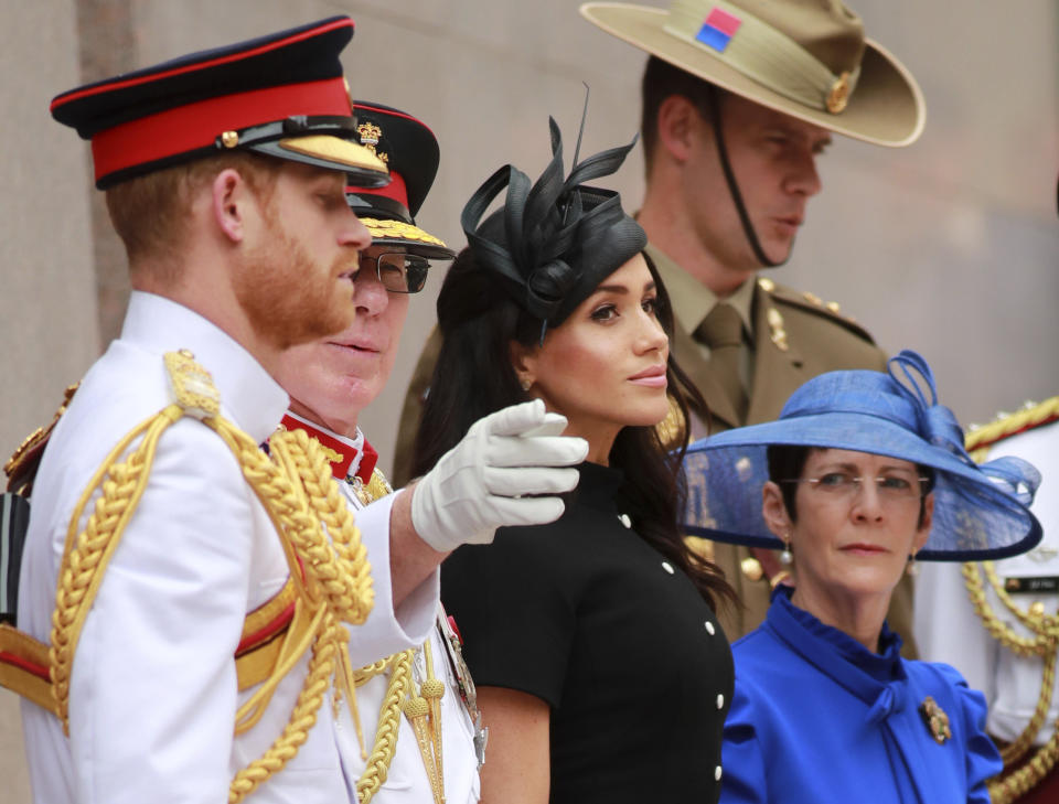 In this Oct. 20, 2018, photo, Britain's Prince Harry, left, and his wife Meghan, center, the Duchess of Sussex attend the opening of Anzac Memorial at Hyde Park in Sydney, Australia. Prince Harry and his wife Meghan, Duchess of Sussex, are on a 16-day tour to Australia and the South Pacific. (Ian Vogler/Pool Photo via AP, File)