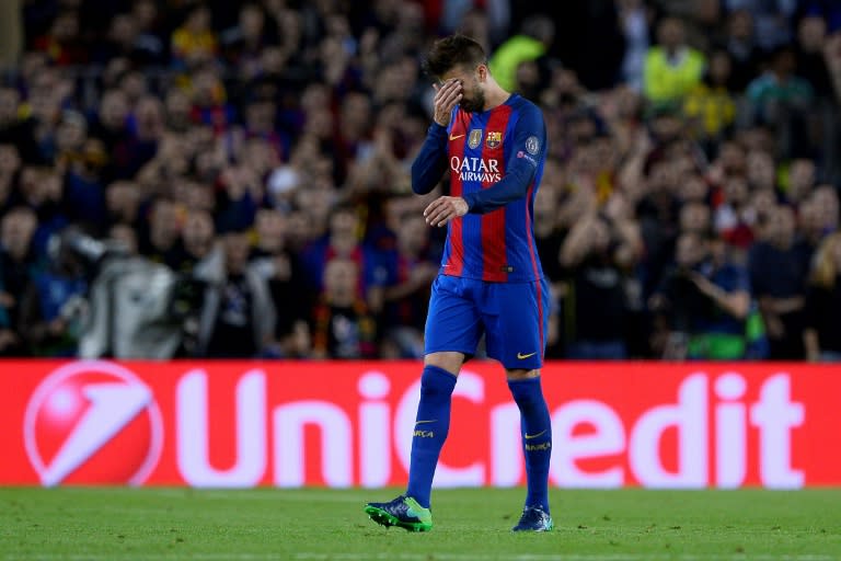 Barcelona's defender Gerard Pique gestures as he leaves the pitch after resulting injured during the UEFA Champions League football match FC Barcelona vs Manchester City at the Camp Nou stadium in Barcelona