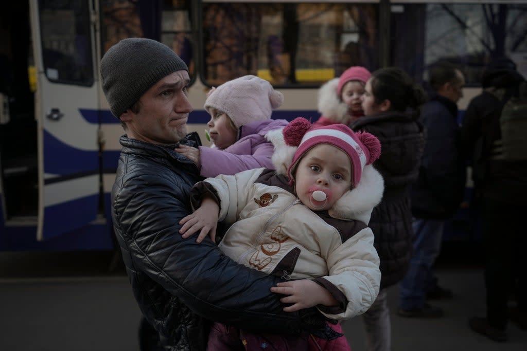Refugees wait for Ukrainian police to check their papers and belongings (Vadim Ghirda/AP/PA) (AP)