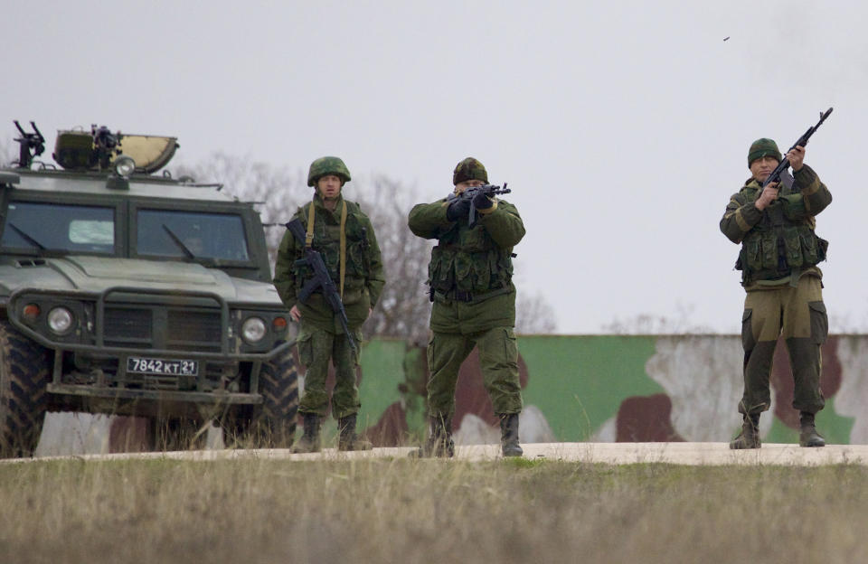 Russian soldiers fire warning shots at the Belbek air base, outside Sevastopol, Ukraine, on Tuesday, March 4, 2014. Russian troops, who had taken control over Belbek airbase, fired warning shots in the air as around 300 Ukrainian officers marched towards them to demand their jobs back. (AP Photo/Ivan Sekretarev)