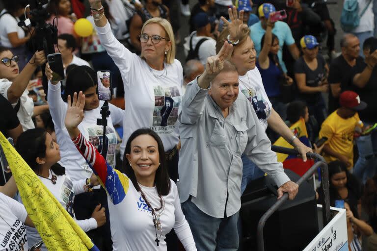 Opposition leader Maria Corina Machado, left, and the opposition's presidential candidate Edmundo Gonzalez wave during a closing election campaign rally in Caracas, Venezuela, Thursday, July 25, 2024. The presidential election is set for July 28. (AP Photo/Cristian Hernandez)