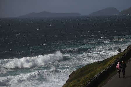 People look out at rough sea from Slea Head during Storm Ali in Coumeenoole, Ireland, September 19, 2018. REUTERS/Clodagh Kilcoyne