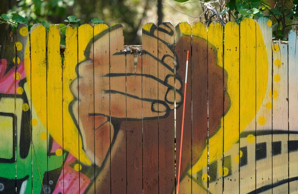 A mural on a fence is displayed at United Fort Worth, a grassroots community organization in Fort Worth, Texas, Tuesday, Aug. 10, 2021.  The Census Bureau is due to release new data on the nation's changing population. The numbers scheduled to come out Thursday, Aug. 12 will show that dozens of counties across 18 states no longer have a majority racial or ethnic group.(AP Photo/LM Otero). ORG XMIT: TXMO107