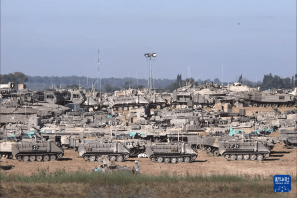 大批以軍裝甲車在以色列南部凱雷姆沙洛姆口岸附近部署。   圖：翻攝自新華網